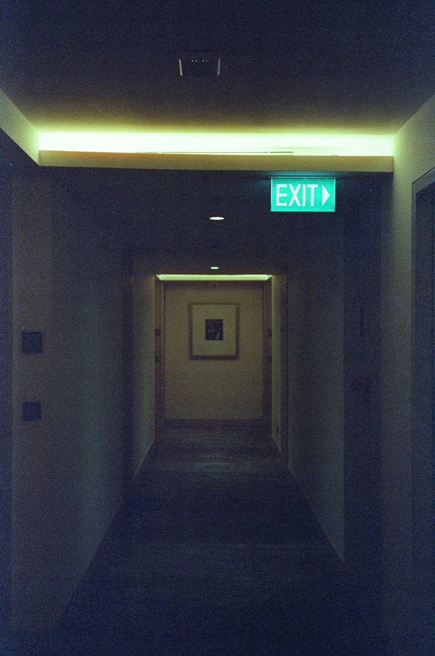 Illuminated Exit Through Dark Corridor