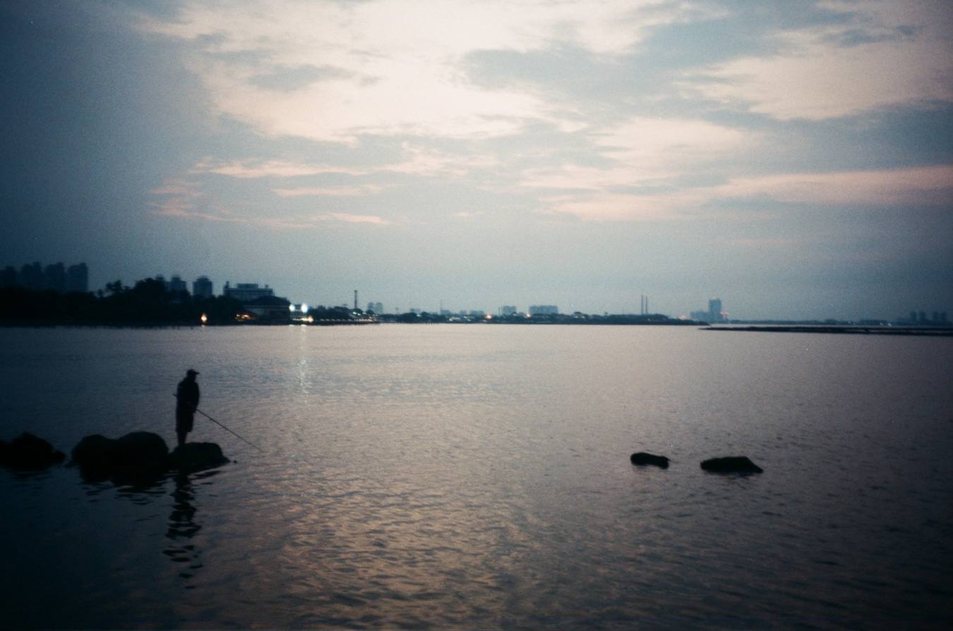 Solitary Evening Fisherman by the Harbour