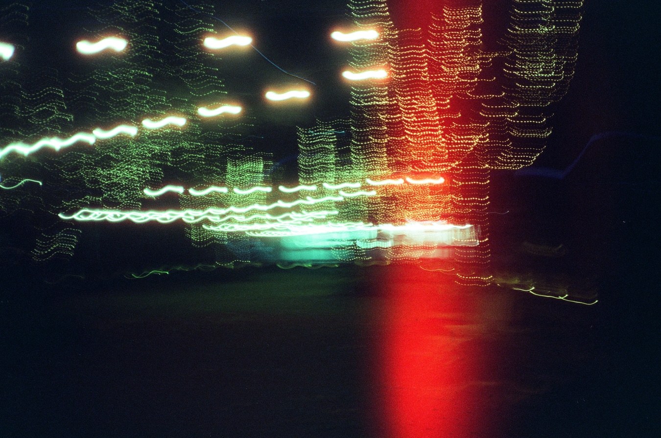 Motion Streaks Through City Night. Shot with Olympus XA-1, Cartenz 200 film