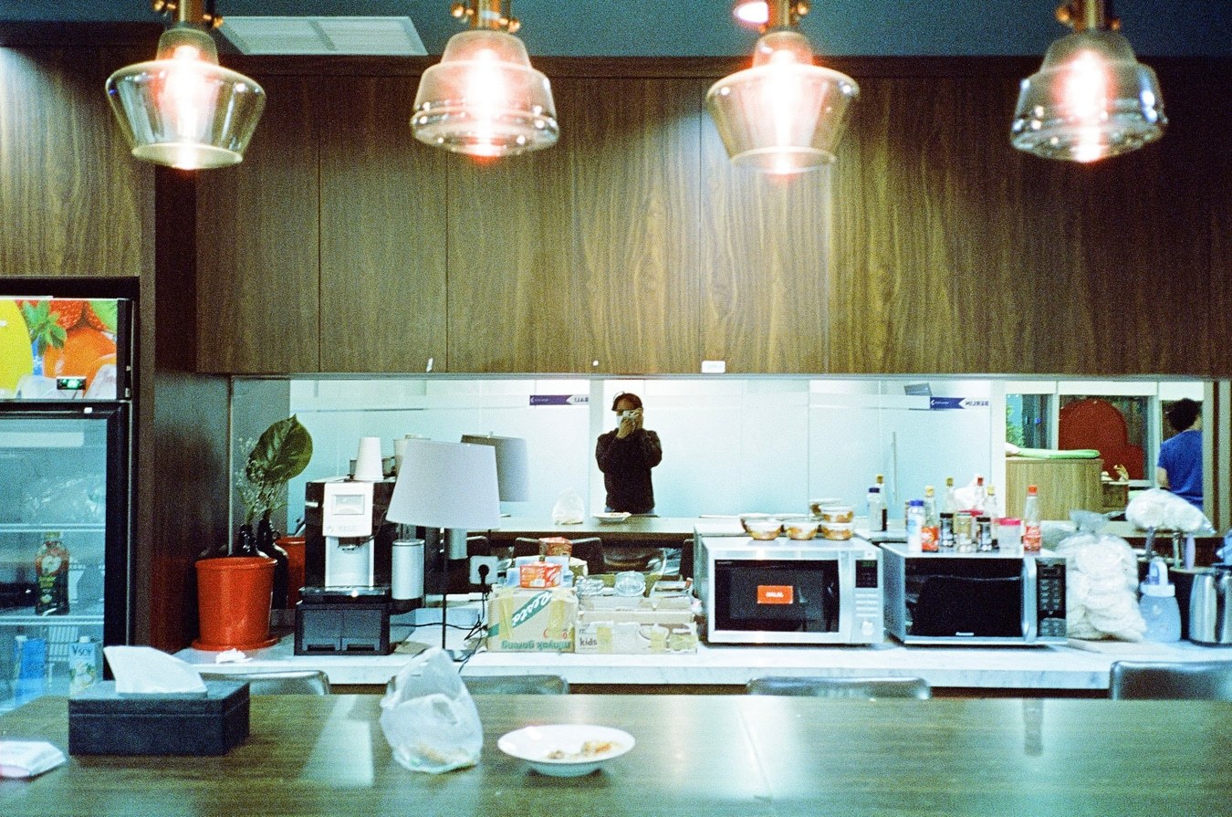 Warm Office Kitchen Reflection. Shot with Olympus Mju II, Cinestill 800T film