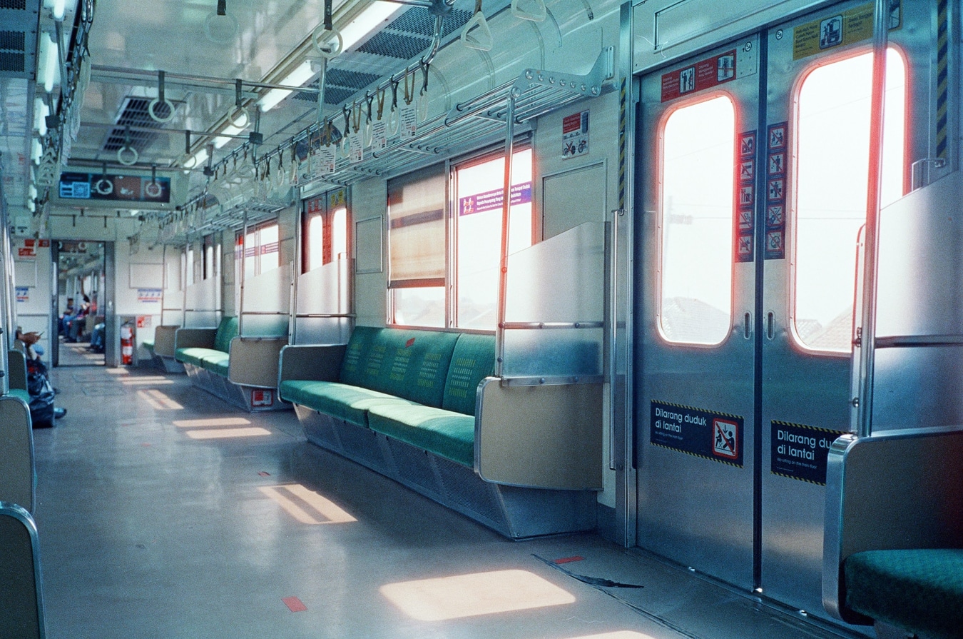 Sunlit Train Interior with Turquoise Seats